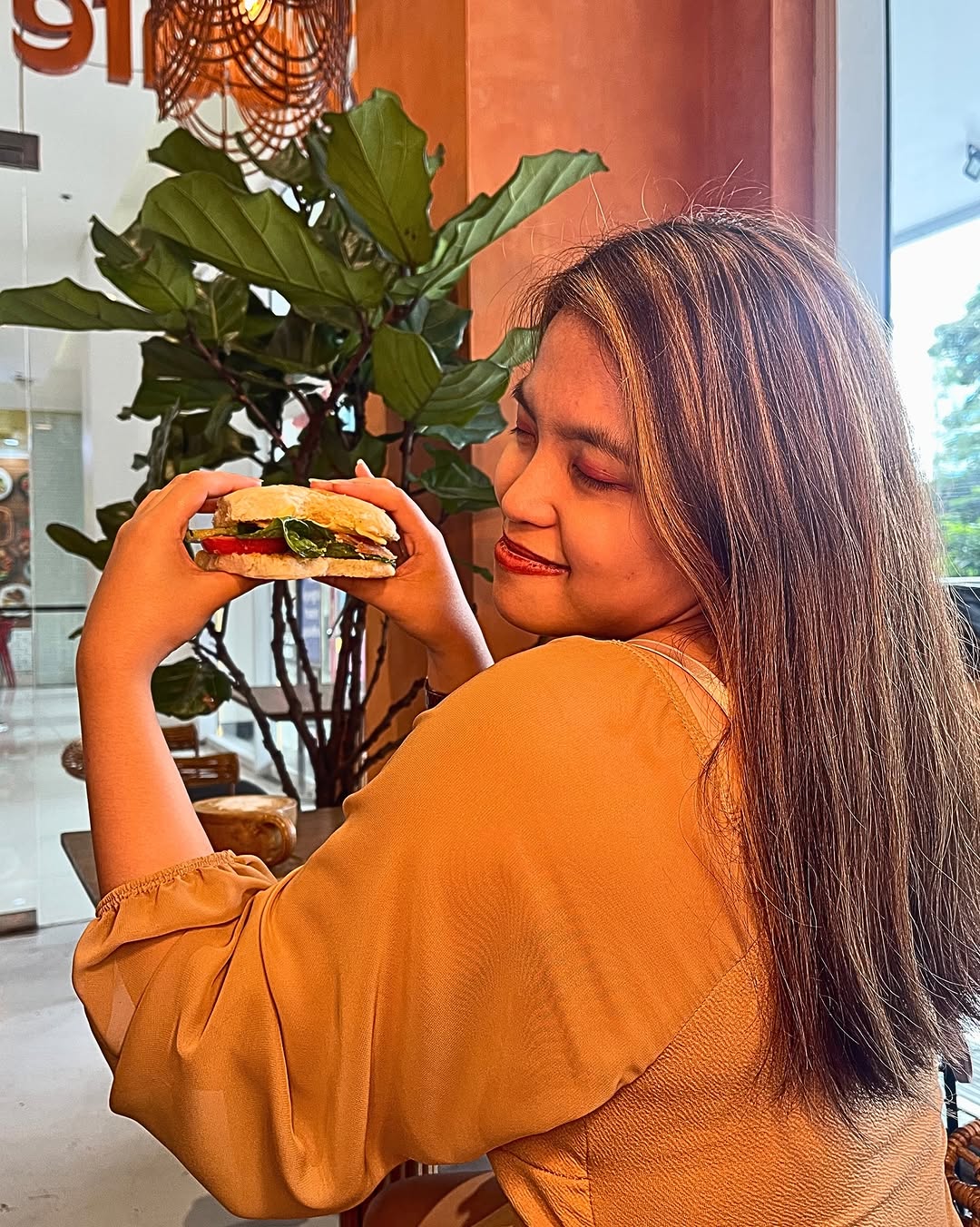 Fresh sandwich held by café guest